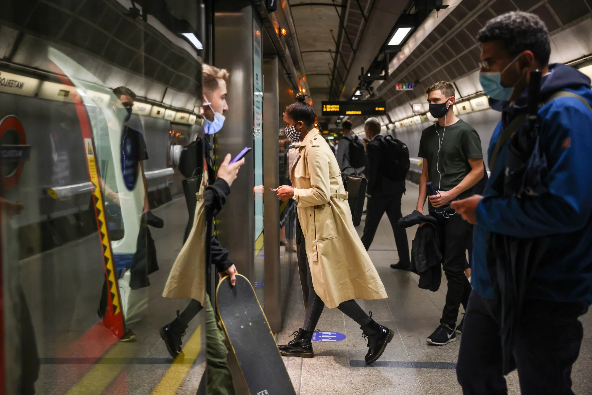 Commuters board an underground train at Waterloo underground station in London on&nbsp;July 12.&nbsp;