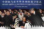 Chinese Foreign Trade Minister&nbsp;Shi Guangsheng&nbsp;signs WTO accession documents in Doha&nbsp;in 2001.