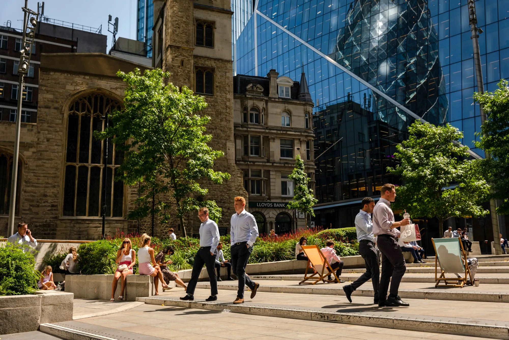 City workers pass through a square at lunchtime in London.