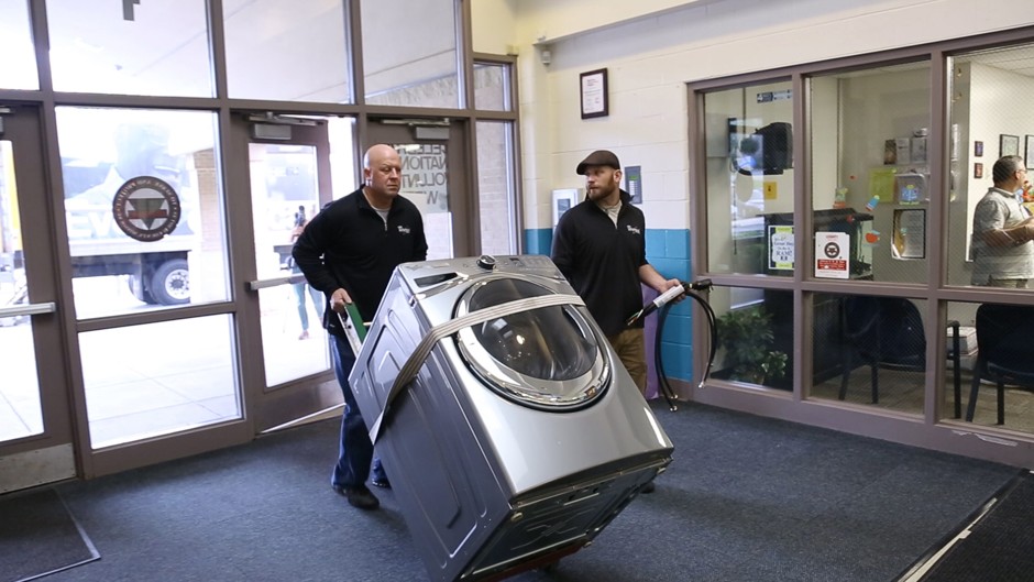 Whirlpool workers make a delivery to a school in the Whirlpool Care Counts Program.