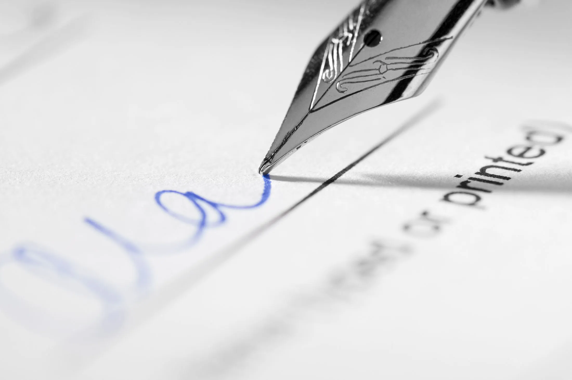 Fountain pen signing signature on paperwork