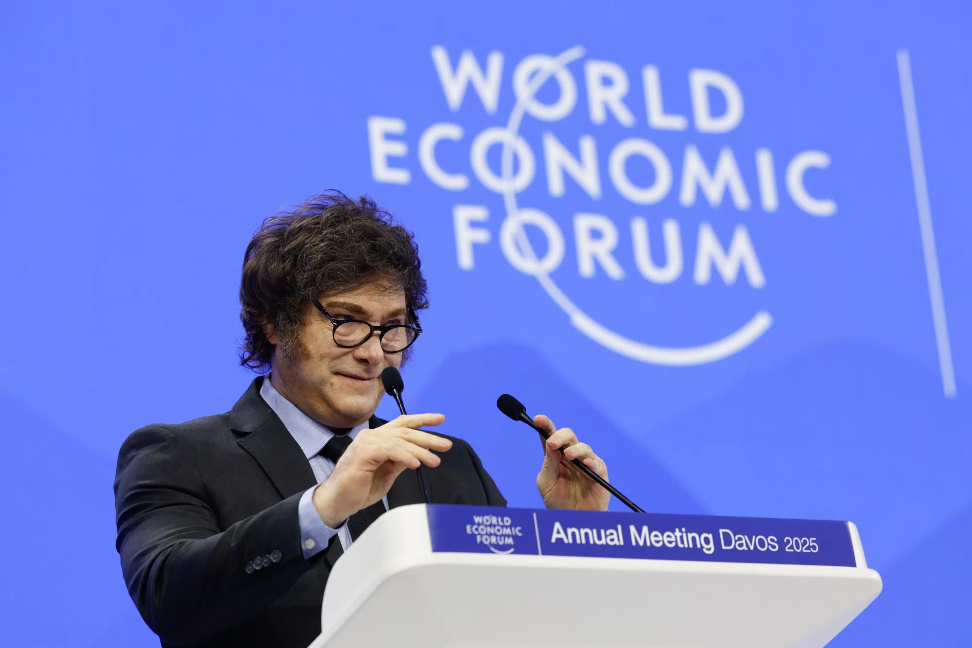 arafed man in suit and tie giving speech at world economic forum