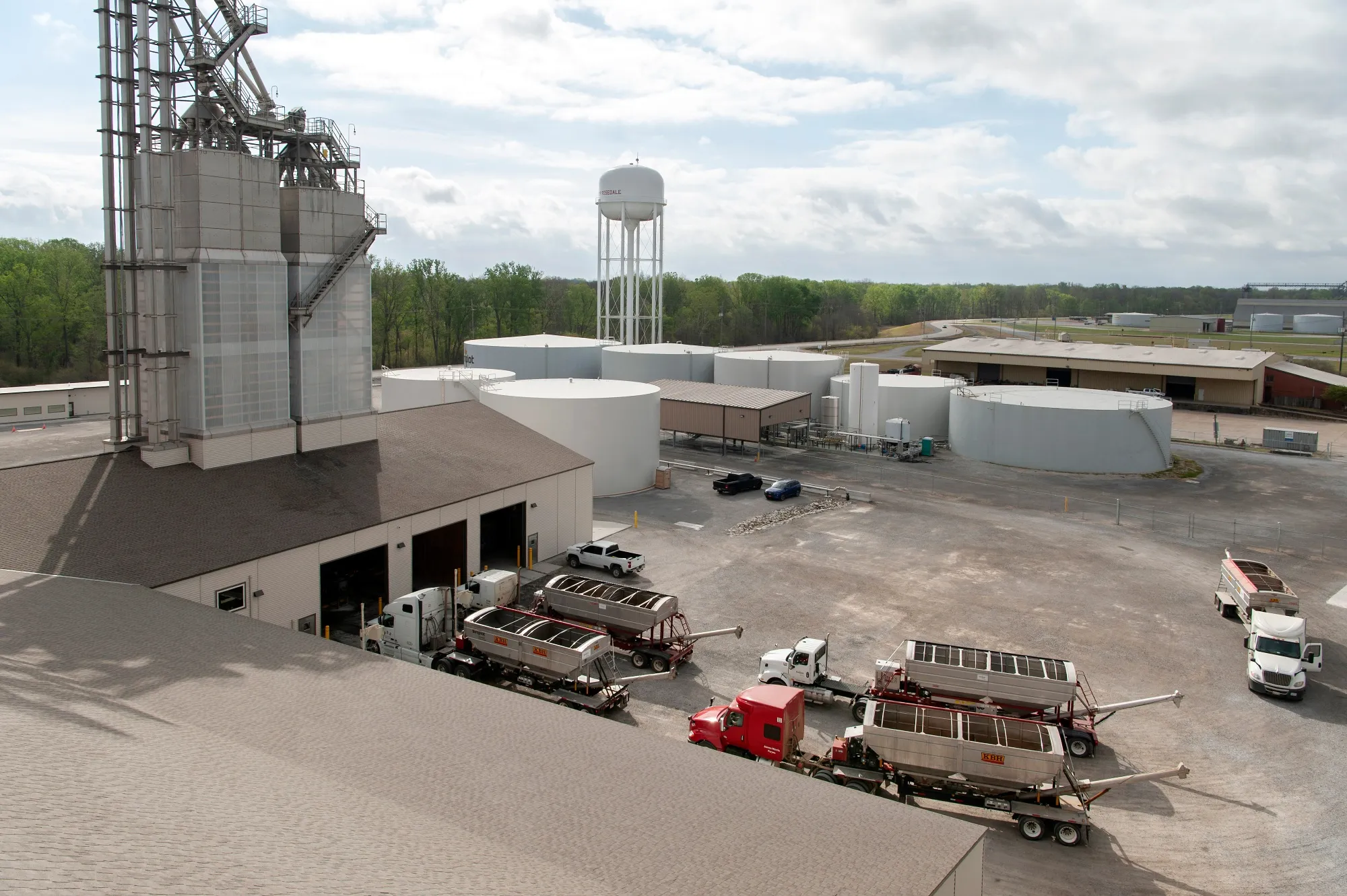 Farm trucks wait in line to fill up their hoppers with fertilizer at a warehouse at the Port of Rosedale in Rosedale, Mississippi.