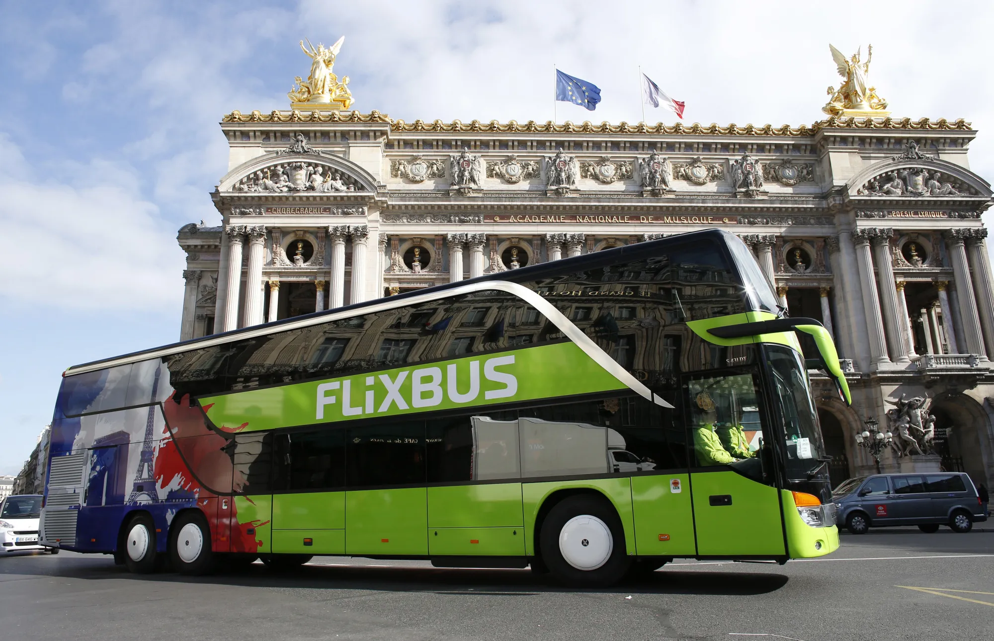 A FlixBus drives past the Palais Garnier opera house.