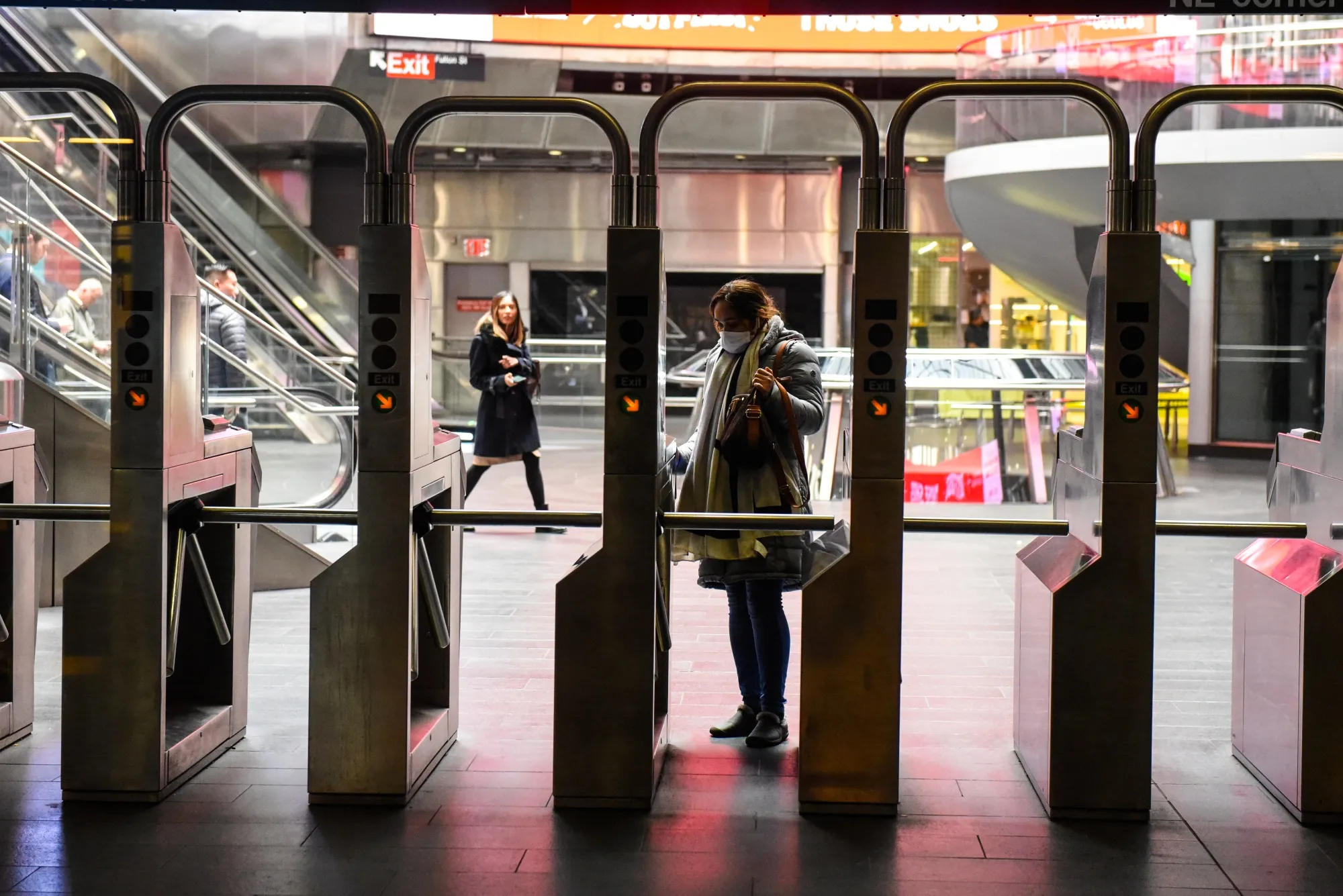 A commuter enters a subway station in New York on March 22, 2023. 
