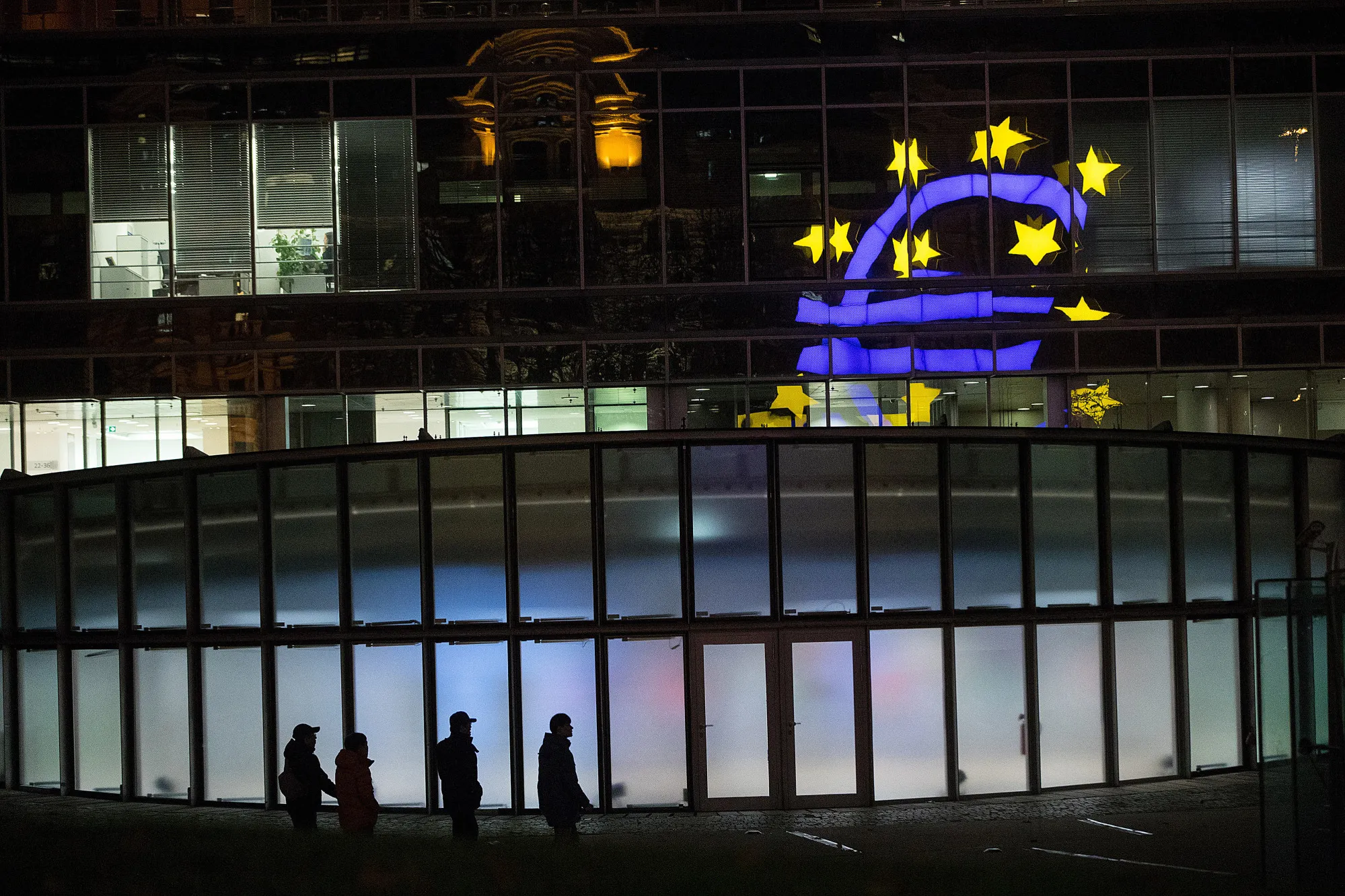 The euro sign sculpture is reflected in office windows near the former European Central Bank&nbsp;headquarters&nbsp;in Frankfurt.