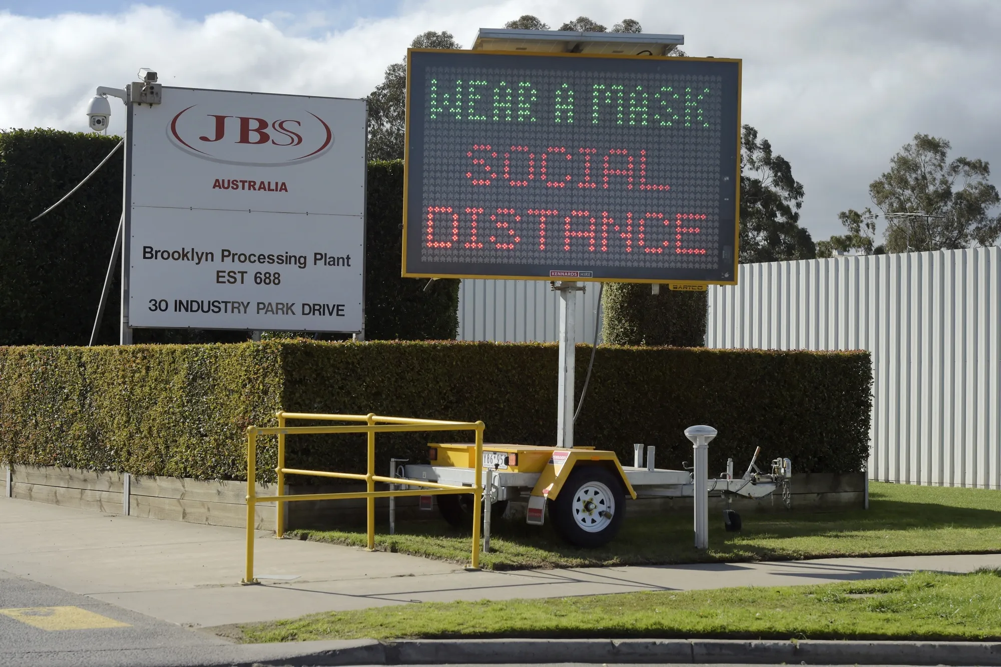 An LED sign displays the message ‘Wear A Mask, Social Distance’ at the entrance to the Brooklyn Processing Plant in Melbourne on Aug. 12.