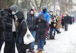 Residents wait in line outside a Covid-19 testing center in Montreal, Quebec, on Dec. 22, 2021.