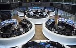Traders monitor financial data as the DAX index curve shows stock information inside the Frankfurt Stock Exchange, operated by Deutsche Boerse AG, in Frankfurt, Germany.