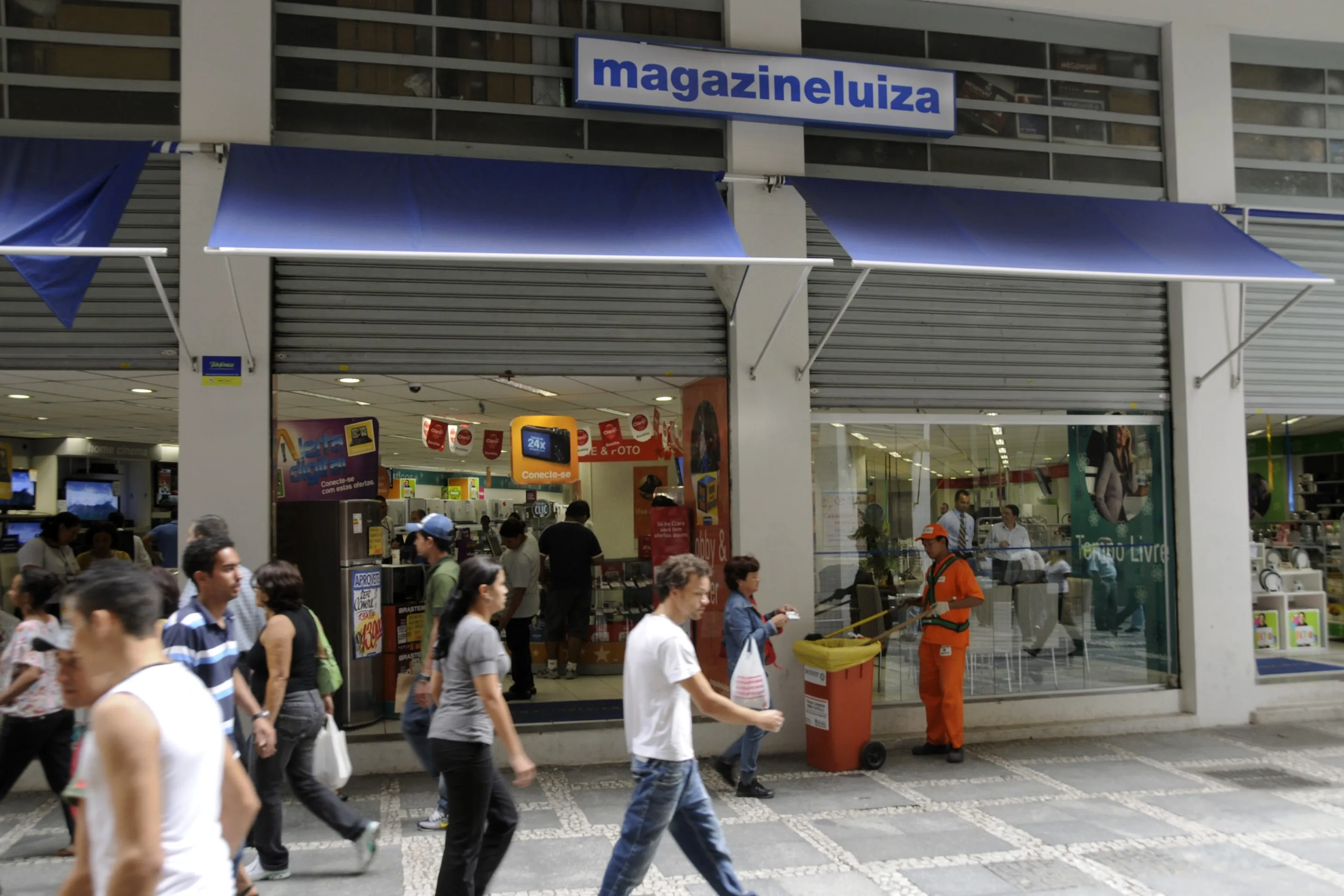 Pedestrians pass in front of a Magazine Luiza SA store in Sao Paulo, Brazil.