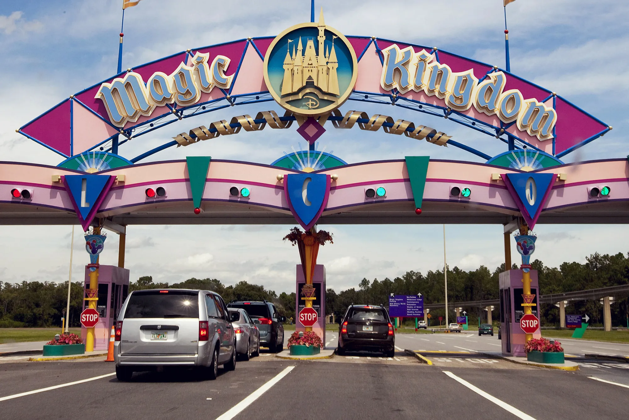 Vehicles stop at the payment entrance to Magic Kingdom at the Walt Disney World theme park and resort in Lake Buena Vista, Florida, U.S., on Monday, Aug. 31, 2009. Walt Disney Co. said it agreed to buy Marvel Entertainment Inc. for about $4 billion in a stock and cash transaction, gaining comic book characters including Iron Man, Spider-Man and Captain America.

