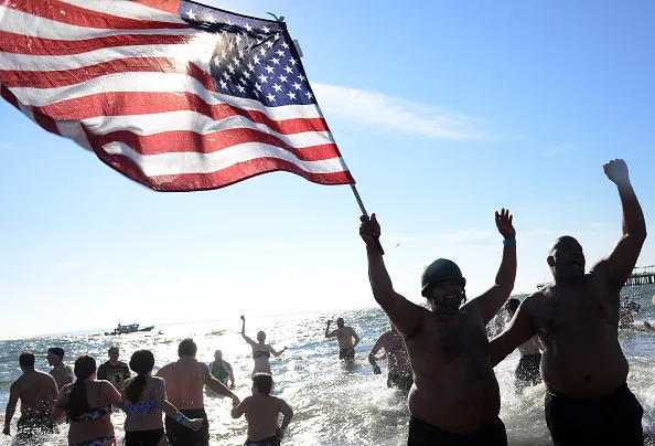 NEW YORK, NY - JANUARY 1, 2015: Members of the Coney Island's Polar Bear Club take an icy dip on New Years Day just off the Boardwalk of Coney Island January 1, 2015 in the Brooklyn borough of New York City.
