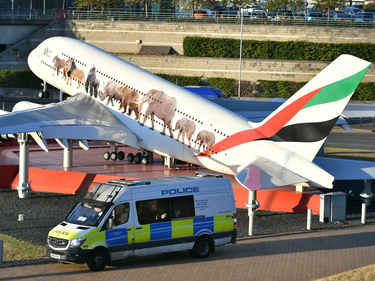 Police monitor for climate change activists at Heathrow on Sept. 13.