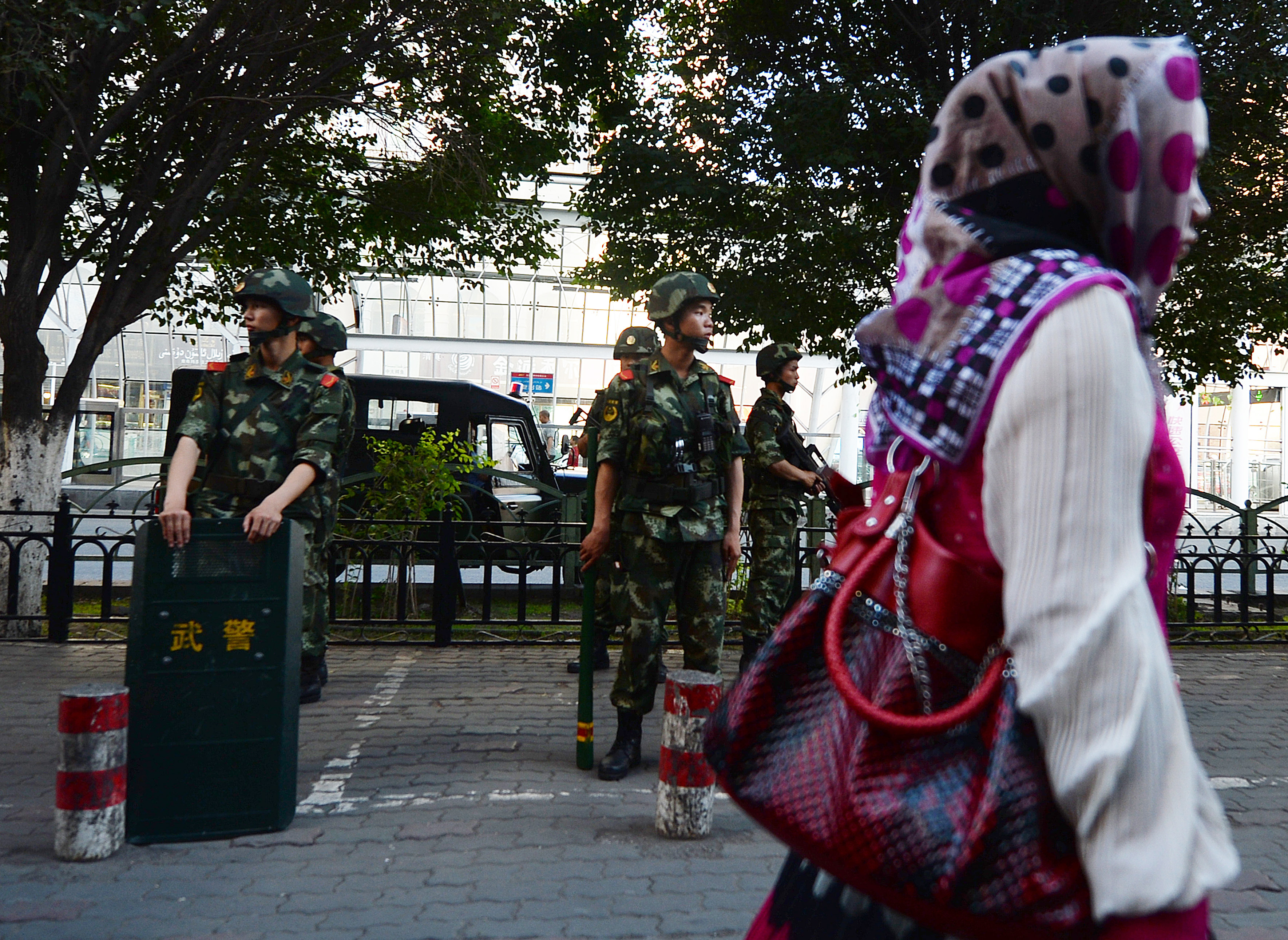 Chinese paramilitary police stand guard in the Muslim Uighur minority area of Urumqi, Xinjiang Province on June 30, 2013.