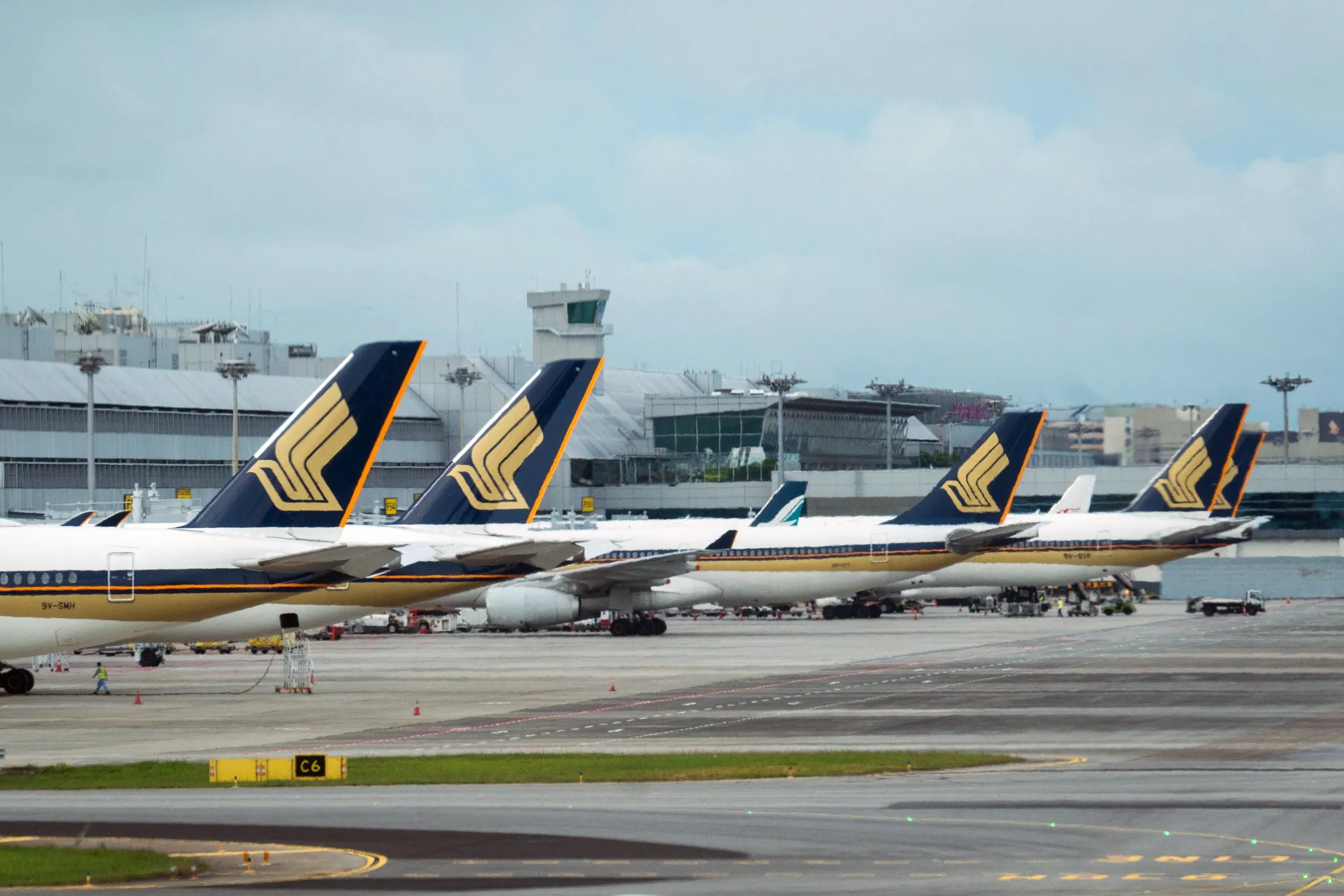 Singapore Airlines Ltd. aircraft stand on the tarmac at Changi Airport in Singapore.