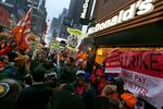 Demonstrators rally for better wages outside a McDonald’s restaurant in New York, as part of a national protest on Dec. 5