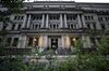 A security guard wearing a protective face mask, left, stands outside the Bank of Japan (BOJ) headquarters in Tokyo.