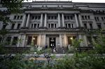 A security guard wearing a protective face mask, left, stands outside the Bank of Japan (BOJ) headquarters in Tokyo.