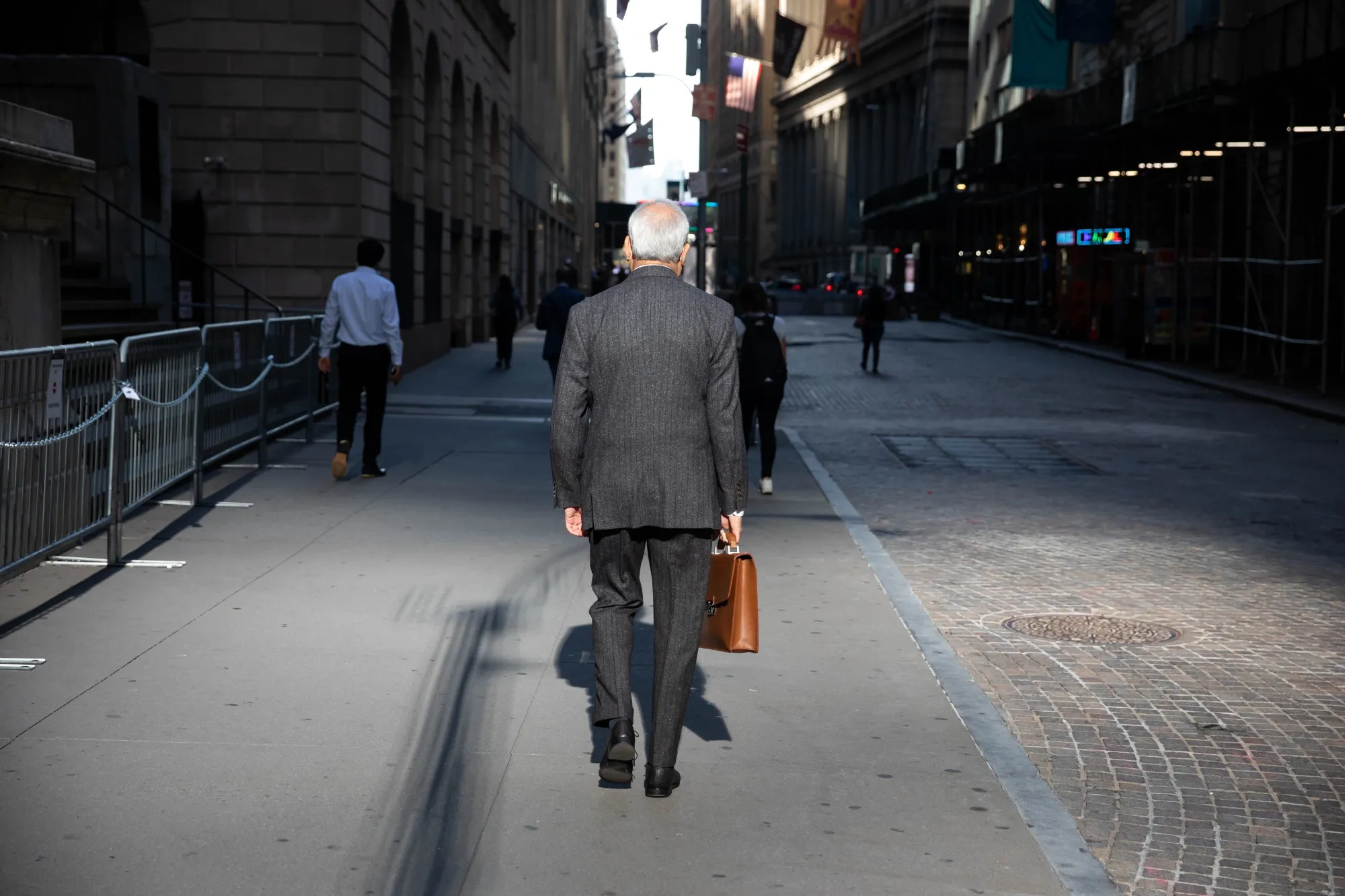 Pedestrians walk along Wall Street&nbsp;in New York.