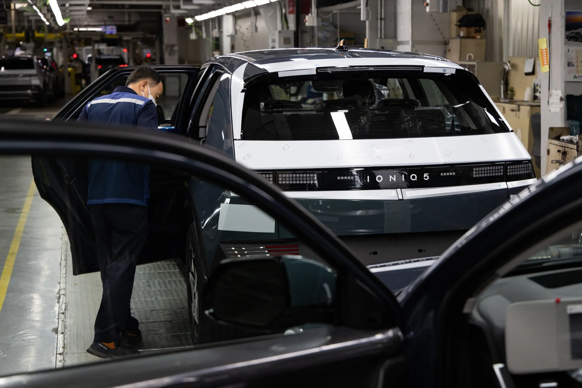 An employee inspects a Hyundai Ioniq 5 electric car&nbsp;at the company's plant in Ulsan.
