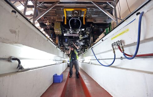 An employee works on the bogey of a London Underground train carriage at the Bombardier factory in Derby, U.K.