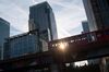 A Docklands Light Railway (DLR) train travels from Heron Quay through the Canary Wharf financial, business and shopping district in London, U.K., on Monday, Aug. 14, 2017. The Docklands Light Railway, a low-capacity rail system connecting the City of London to the Docklands area that carries 122 million passengers a year, began operating on Aug. 31, 1987.