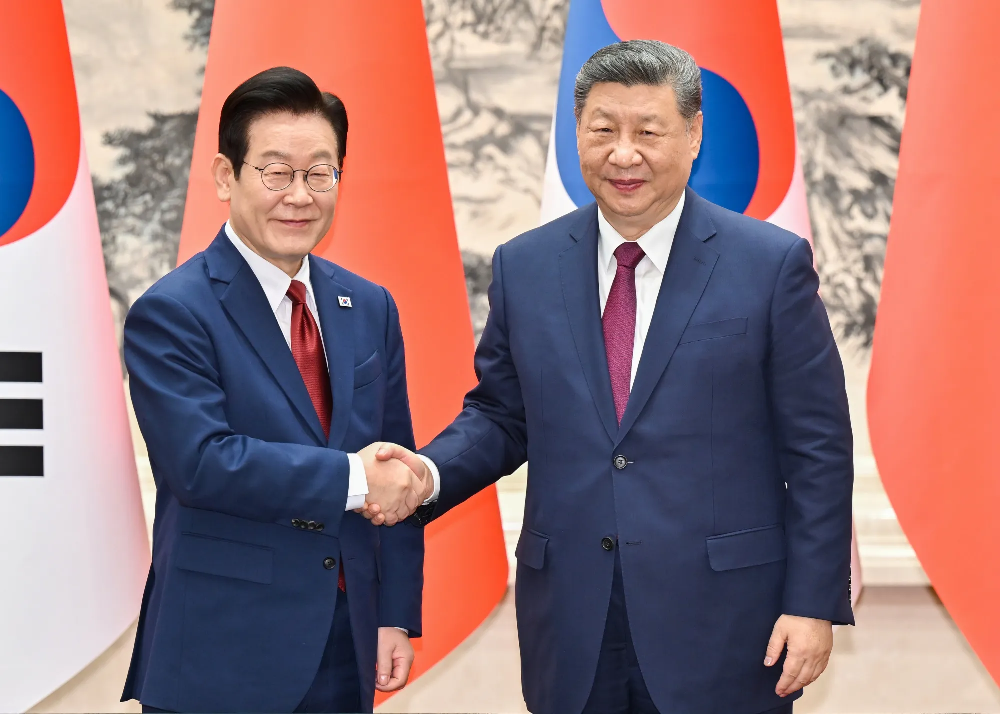 Lee Jae Myung, left, with Xi Jinping in Beijing on, Jan. 5.