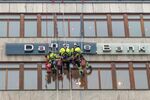 Workers maintain the "Danske Bank" sign in Stockholm.