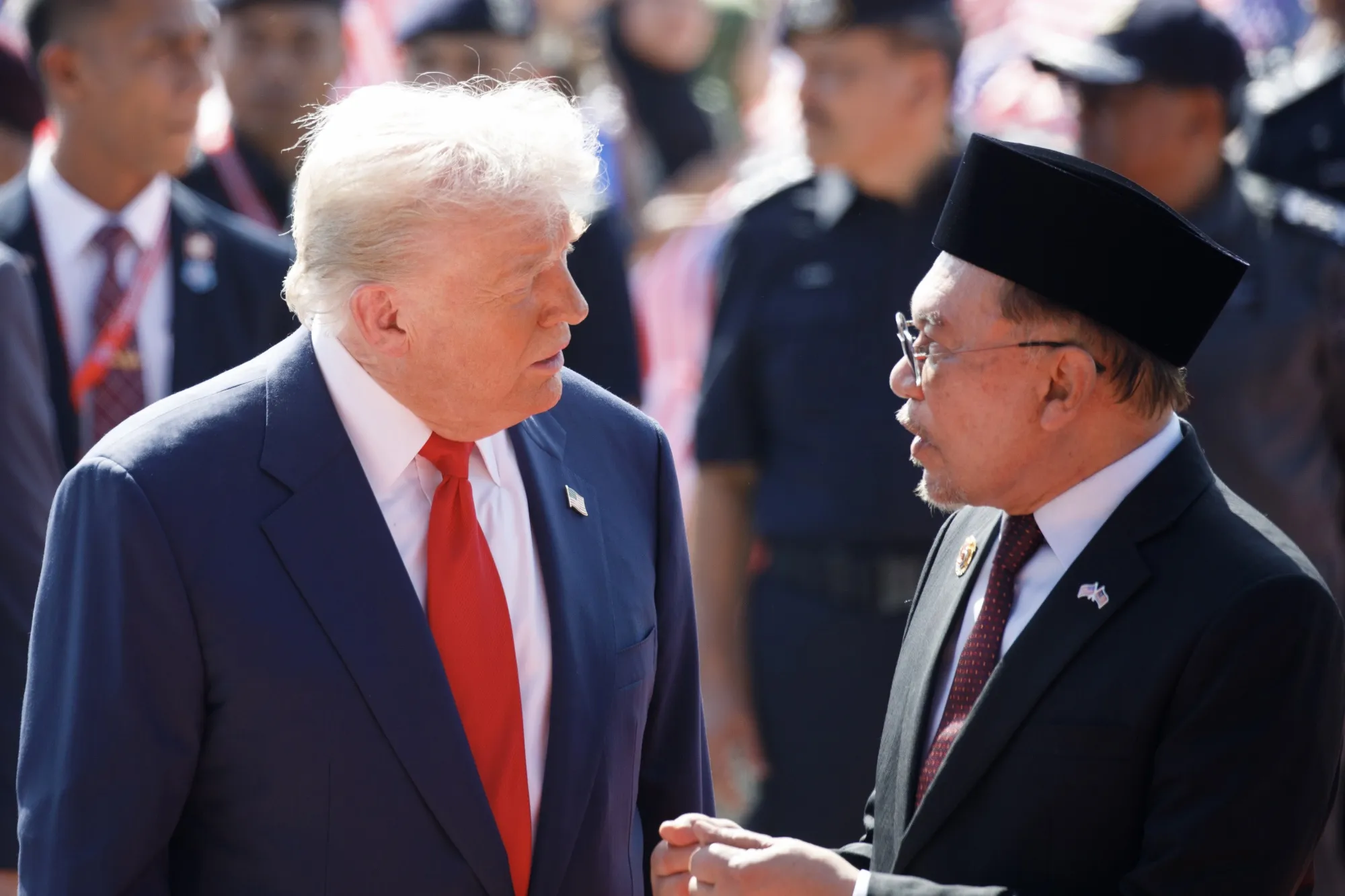 Donald Trump speaks with Anwar Ibrahim after arriving at Kuala Lumpur International Airport on Oct. 26.