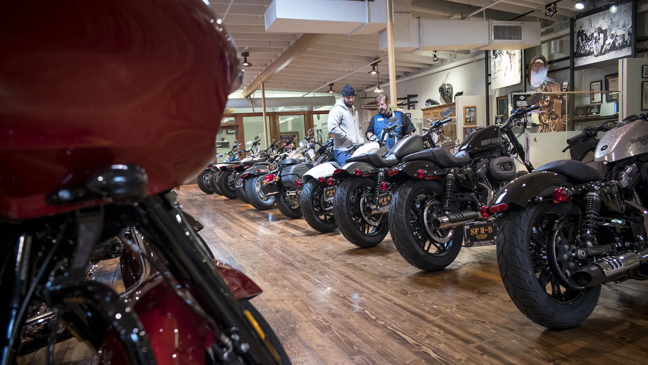 Customers view Harley-Davidson Inc. motorcycles at the company's dealership in South San Francisco, California, U.S., on Tuesday, June 26, 2018. President Donald Trump appeared to turn on an iconic American company he once embraced, accusing Harley-Davidson of using new tariffs on trade as cover to shift some production abroad as he threatened the motorcycle manufacturer with a "big tax" on bikes imported to the U.S.