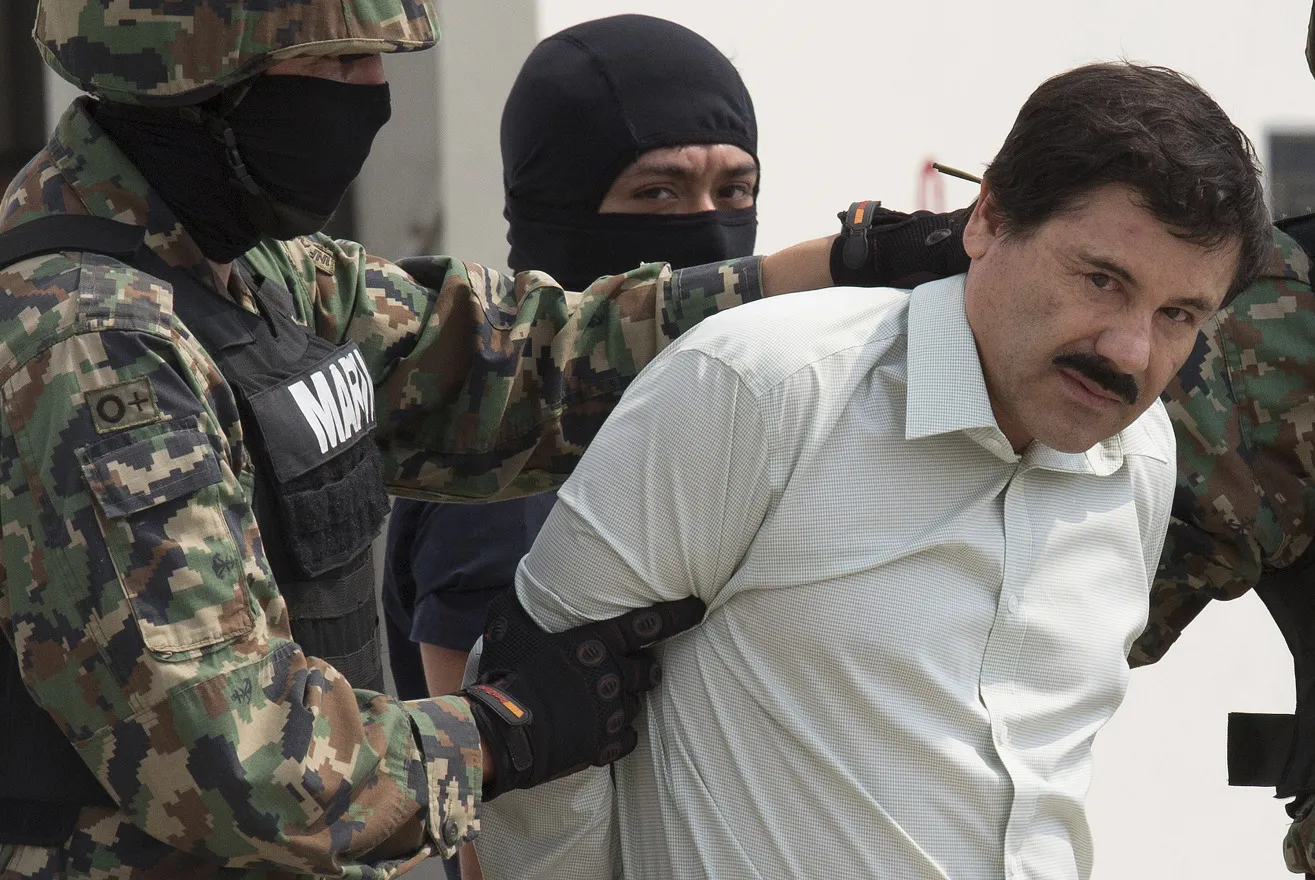 Joaquin "El Chapo" Guzman is escorted to a helicopter by Mexican security forces in Mexico city, on Feb. 22, 2014.