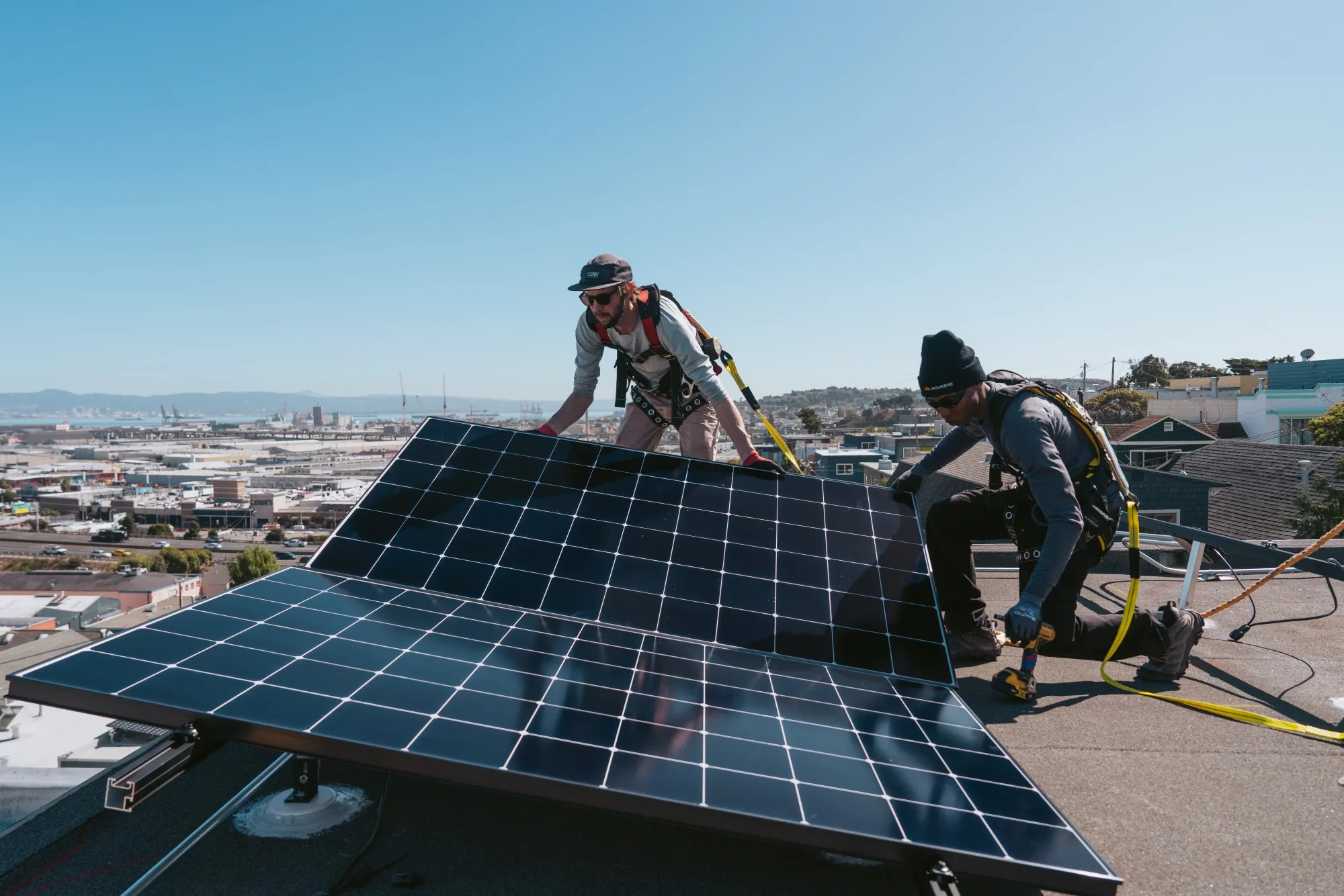 Workers install solar panels on a home in San Francisco, California.