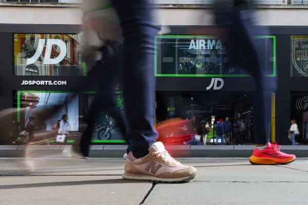 Shoppers pass a JD Sports store in London