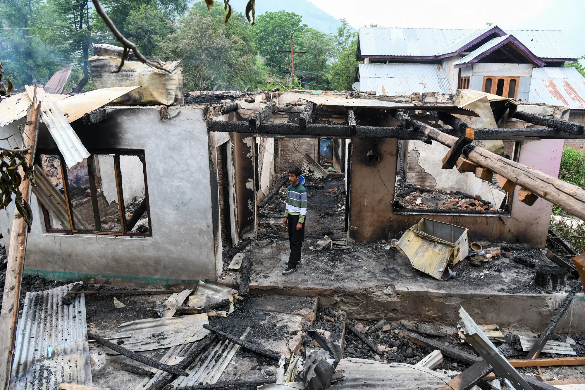 A boy surveys the remains of their damaged house following cross-border shelling between Pakistani and Indian forces in Salamabad uri village on May 8.