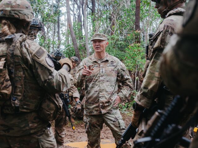 US Army Chief of Staff General Randy George speaks with soldiers during training exercises at the Jungle Operations Training Center in Honolulu.