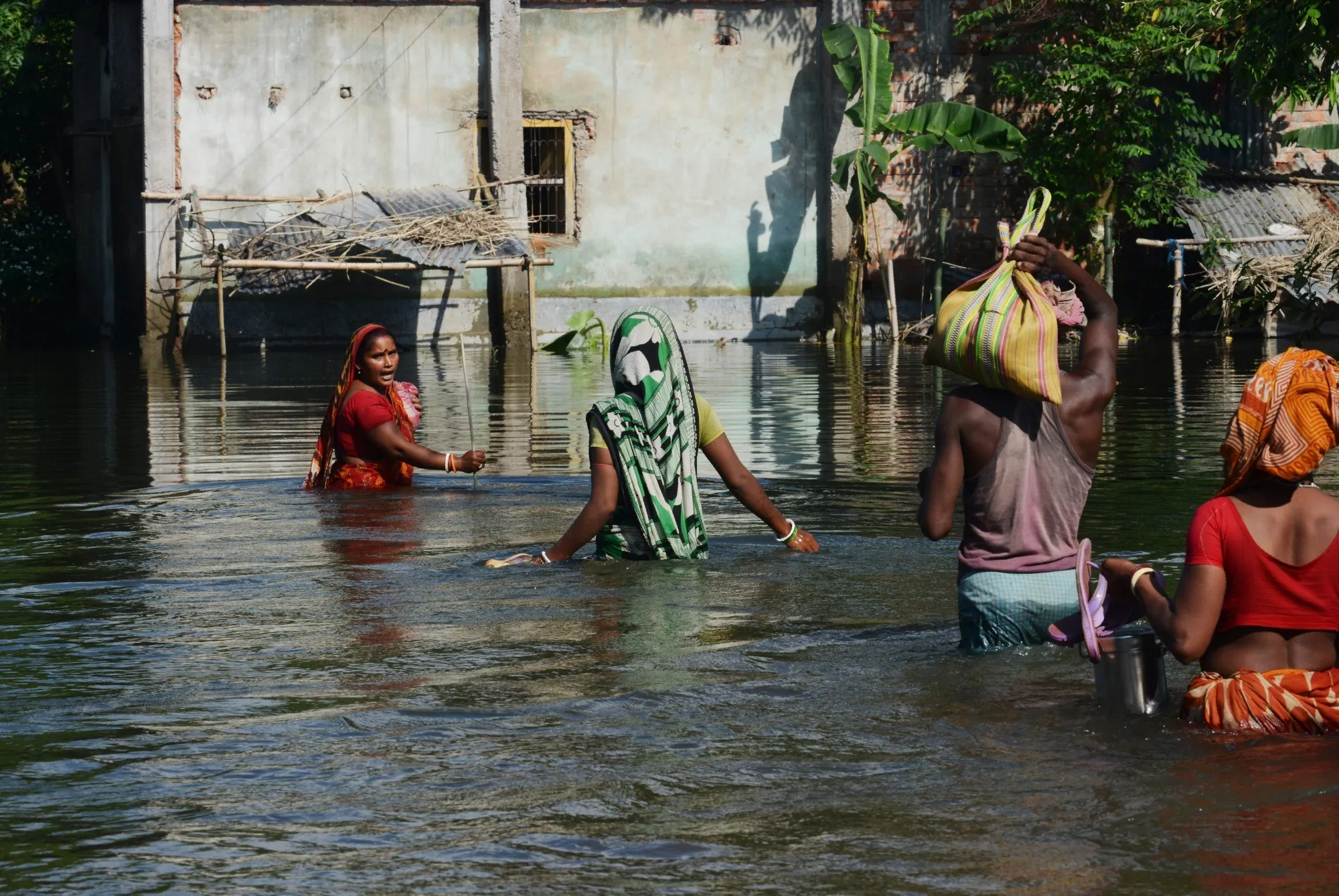 Villagers in West Bengal wade through flood waters on Aug. 23.
