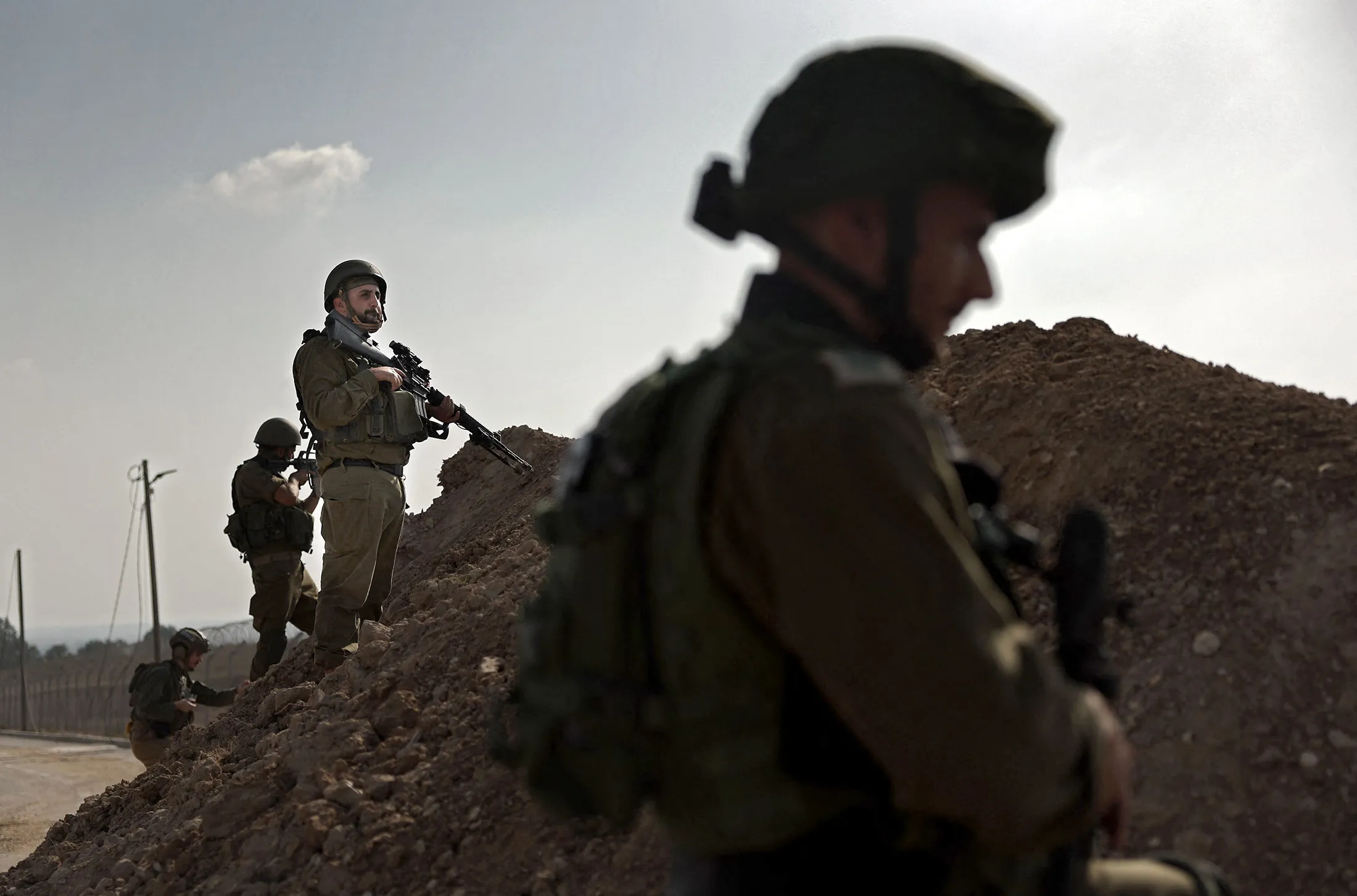Israeli soldiers take a defensive position in Kibbutz Beeri along the border with the Gaza Strip, on Oct. 22.