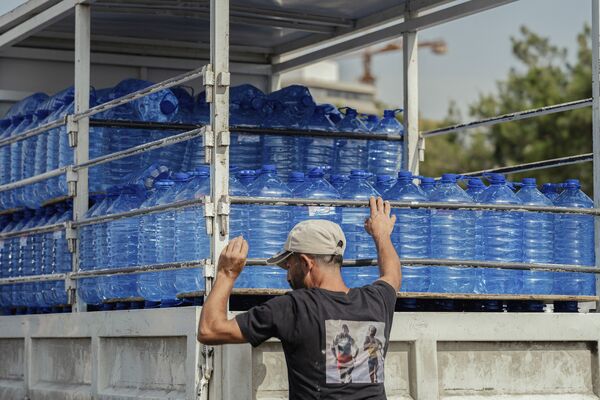 A truck loaded with bottles of water at Zaituna Bay camp for people, who fled southern Lebanon and Beirut's southern suburbs, in Beirut on May 16.