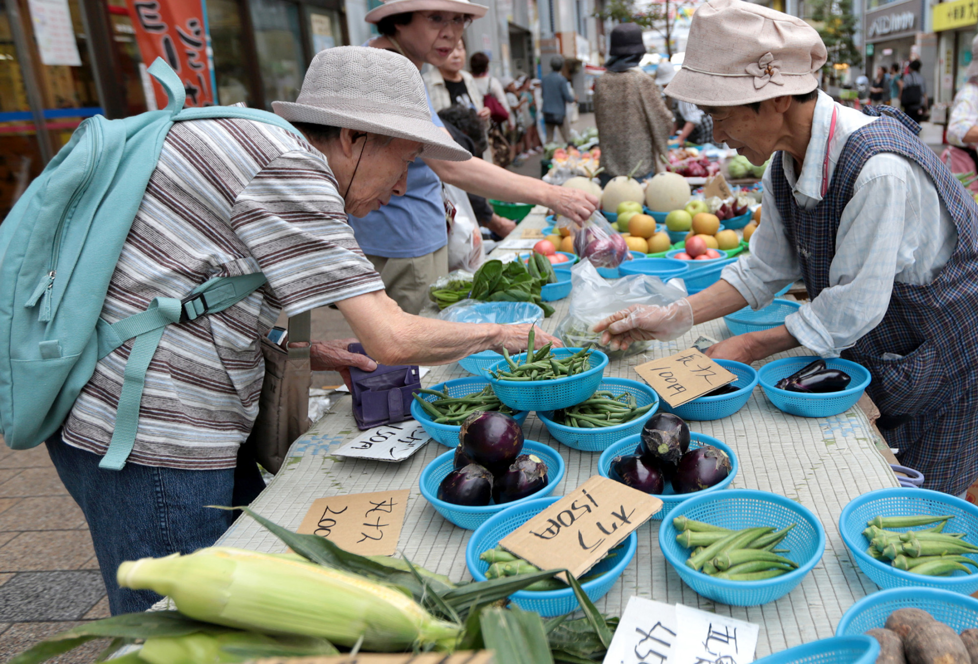 Elderly people buy vegetables at Honcho market in Niigata City, Japan.
