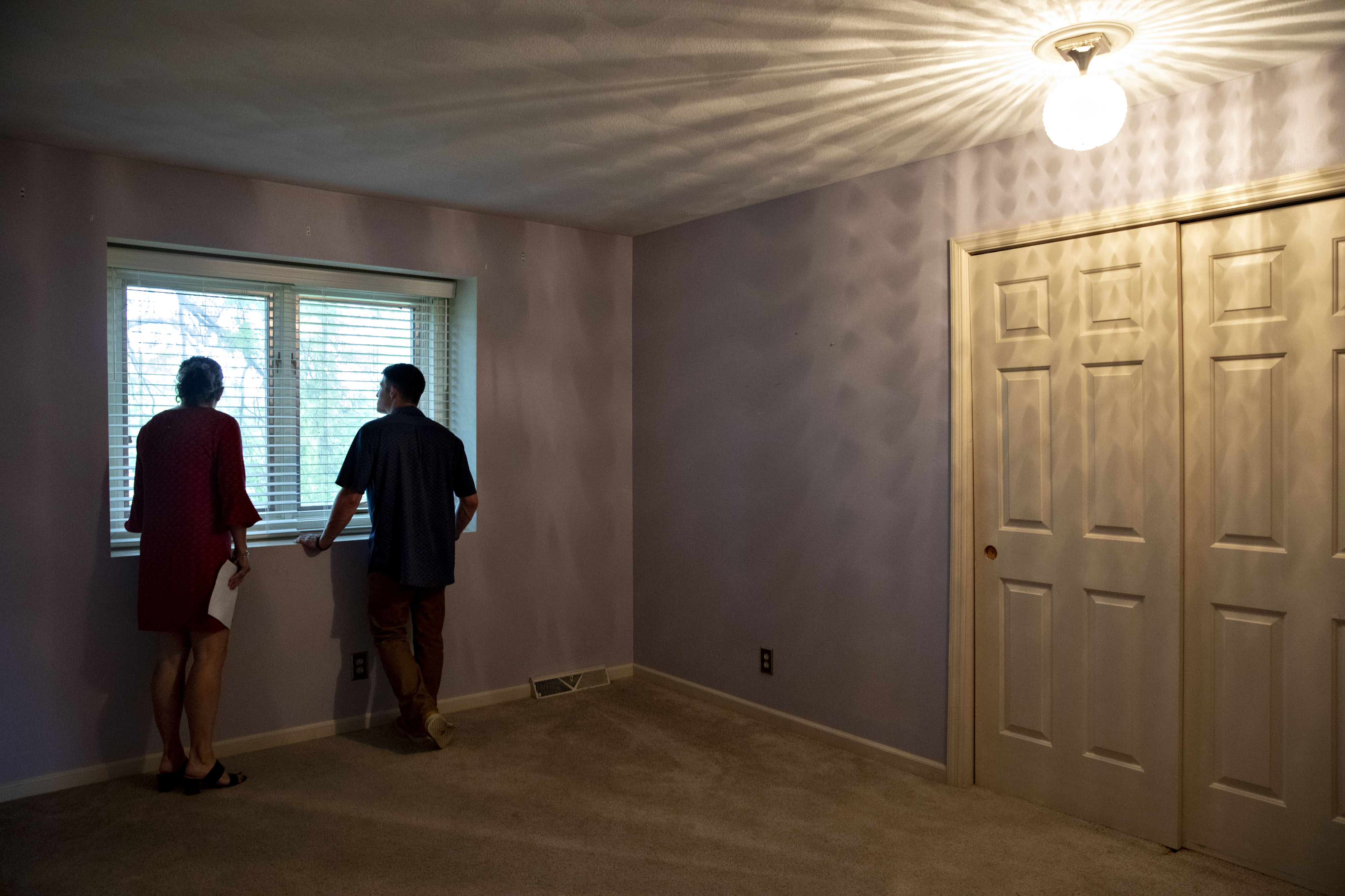A real estate agent shows a prospective home buyer a house for sale in Peoria, Illinois.