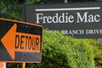 A "detour" sign is posted at the main entrance to the Freddie Mac headquarters on July 14, 2008 in McLean, Virginia. Fannie Mae and Freddie Mac stocks wobbled Monday after a near-meltdown last week, as the market mulled a weekend plan offering a lifeline for the mortgage finance firms from the US Federal Reserve and Treasury. Freddie Mac's shares shot up as much as 26 percent then fell eight percent before steadying in late morning trade with a modest gain of two percent at 7.90 dollars at 1420 GMT. AFP Photo/Paul J. Richards (Photo credit should read PAUL J. RICHARDS/AFP via Getty Images) Photographer: PAUL J. RICHARDS/AFP
