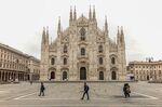 Pedestrians pass the Duomo cathedral in Milan, Italy, on Thursday, March 12, 2020.