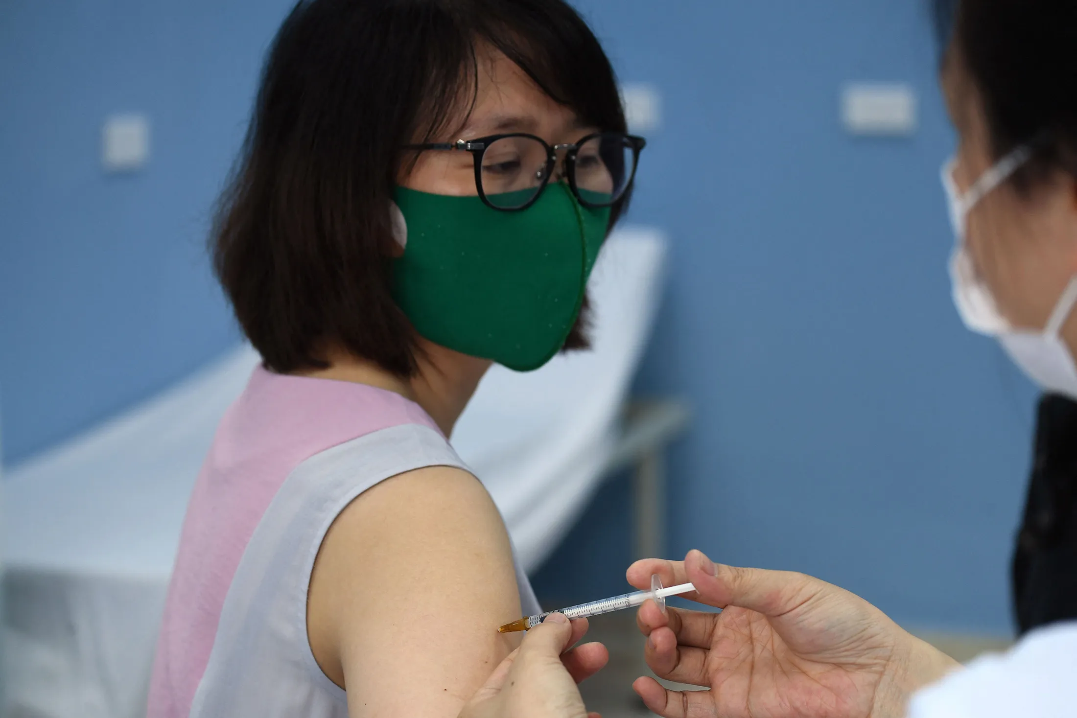 A health worker administers a dose of the AstraZeneca vaccine&nbsp;in Hanoi on May 17.