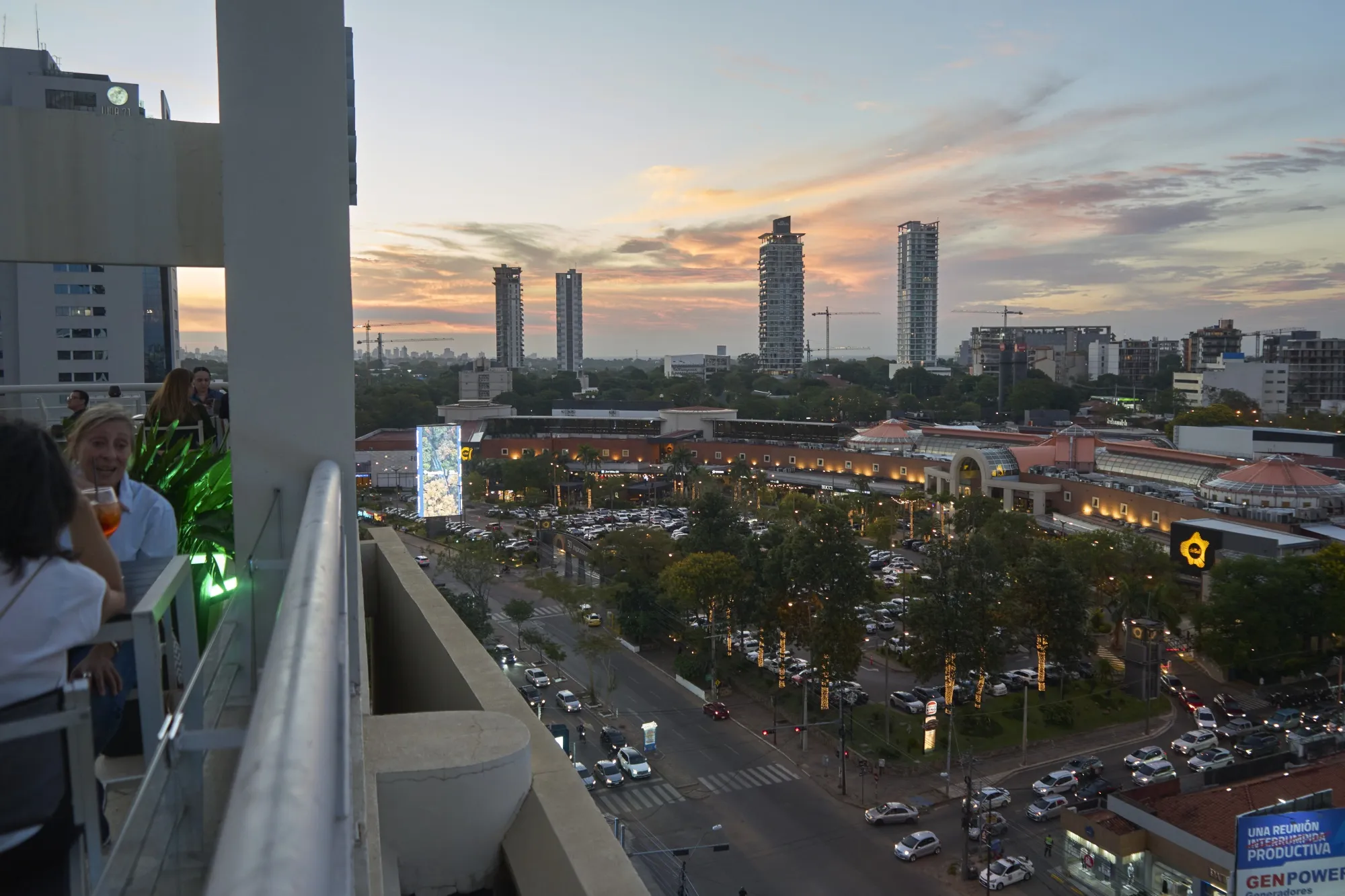 Construction cranes are seen behind the Shopping del Sol mall, right, in&nbsp;the financial district of Asunción.&nbsp;