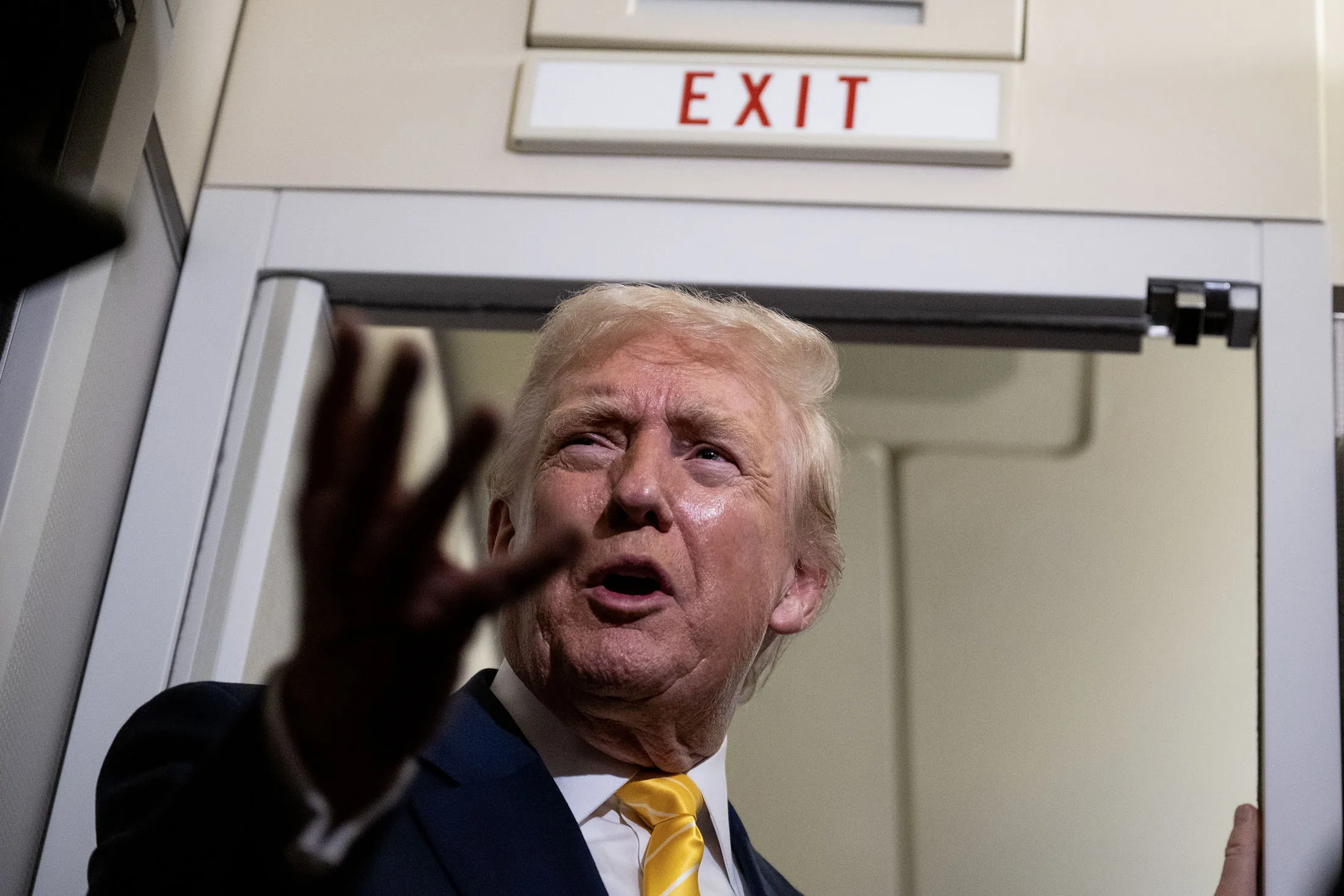 President Donald Trump speaks to members of press aboard Air Force One on November 14, 2025.