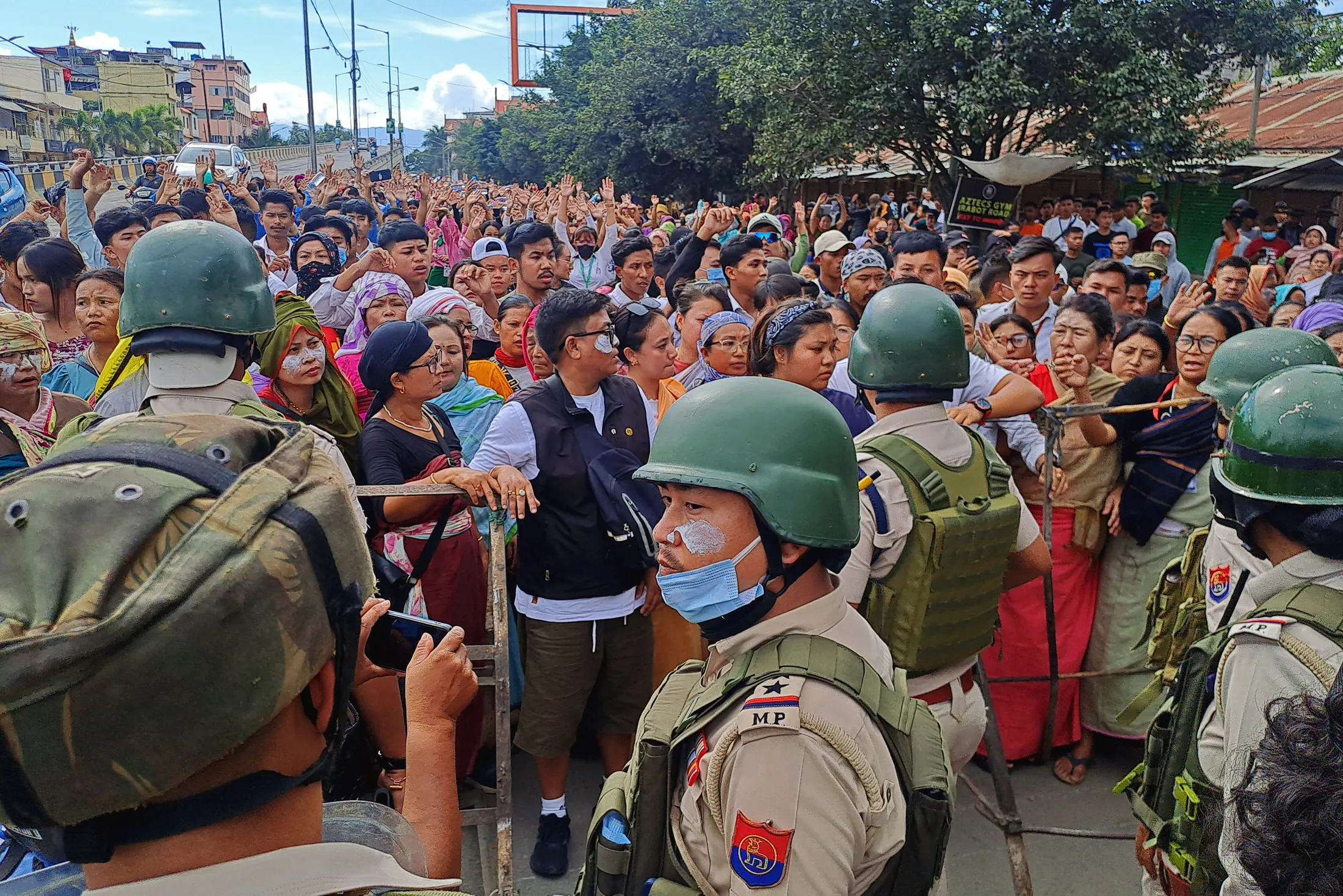 Protesters face security personnel during a curfew in Imphal, Manipur, India, on Sept 10.
