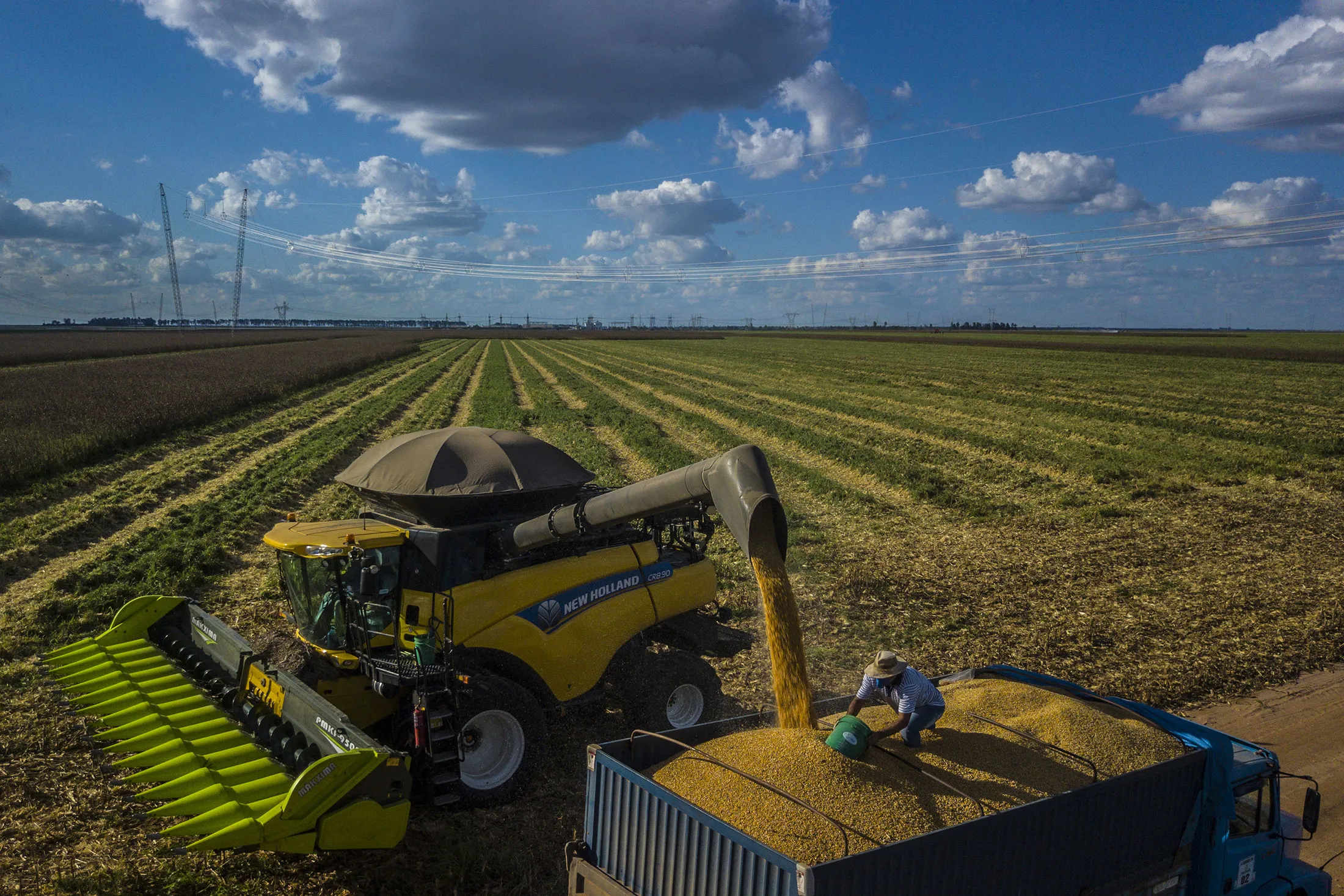 A worker collects corn grain on a truck at a farm in Rosario, Bahia state, Brazil, on Wednesday, May 9, 2018.&nbsp;