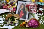 Tributes including flowers calling for a 'remain' vote in the EU referendum are piled in remembrance against a photograph of slain Labour MP Jo Cox in Parliament Square central London on June 18, 2016.
