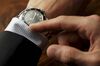 Well-dressed man checking the time on his wristwatch