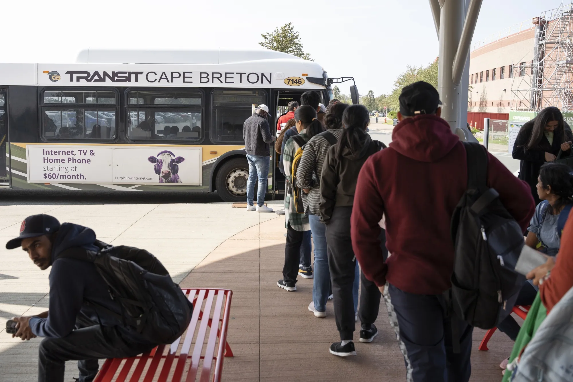 Students wait to board a bus at Cape Breton University in Nova Scotia.